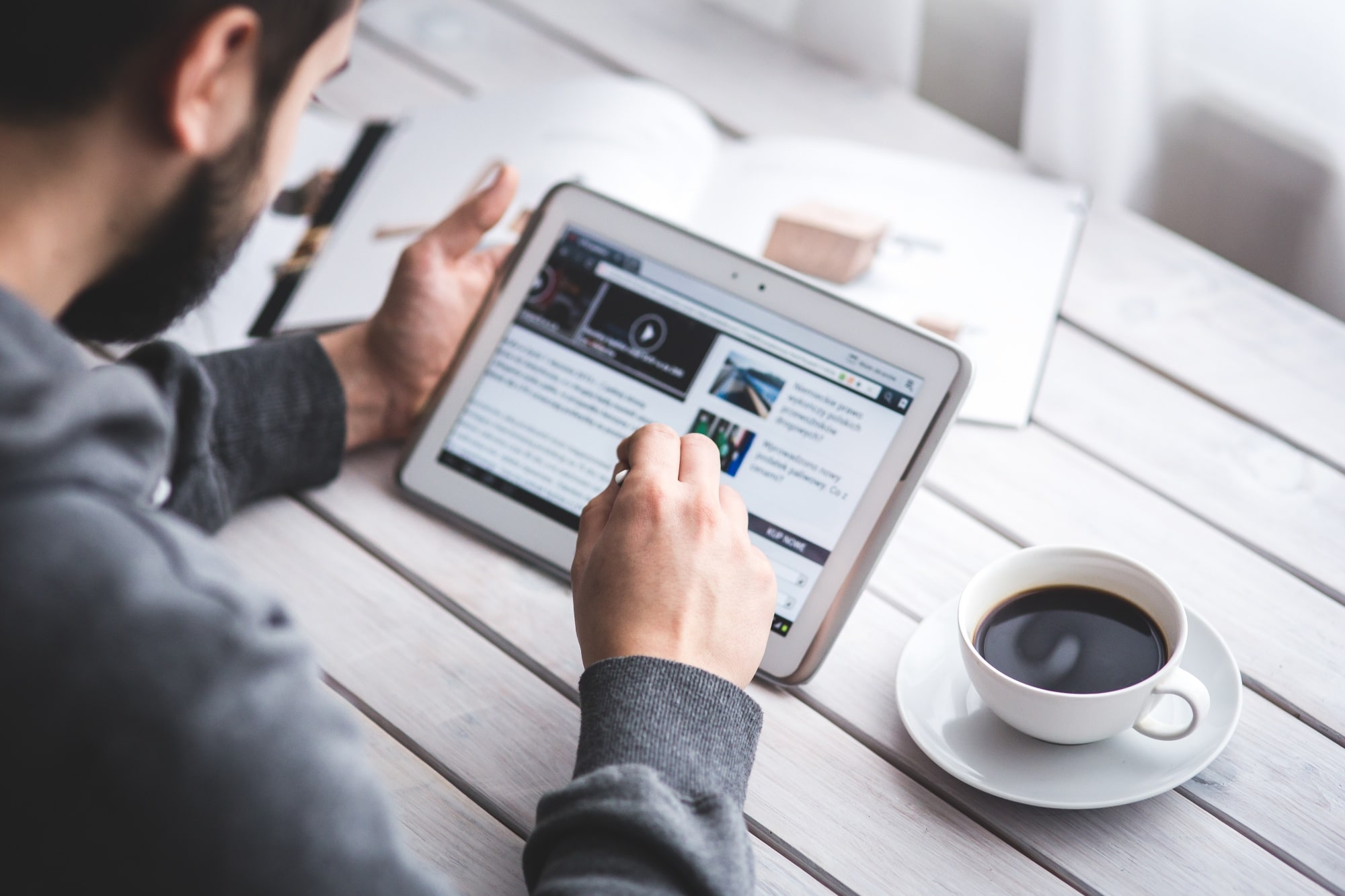 worker-reading-news-with-tablet-min