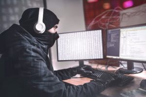 hacker man using her computer organize malware attack global
